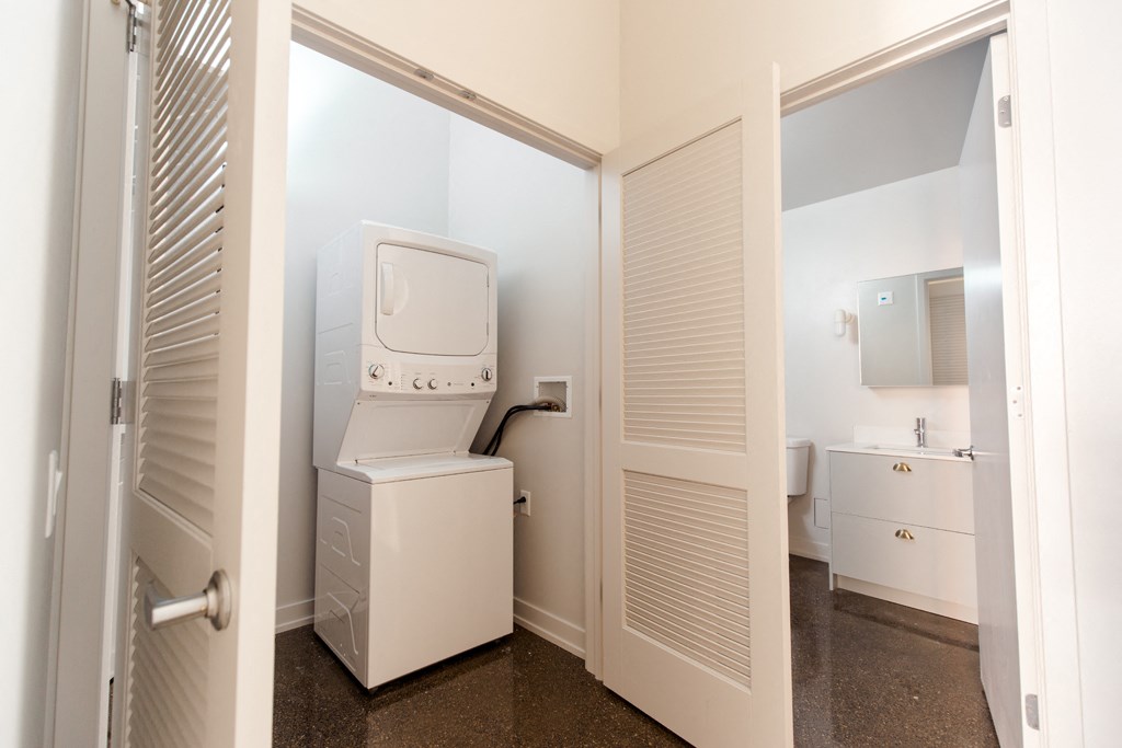 a small bathroom with a washer and dryer in it