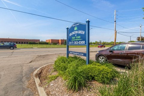 a sign for a car dealership in a parking lot