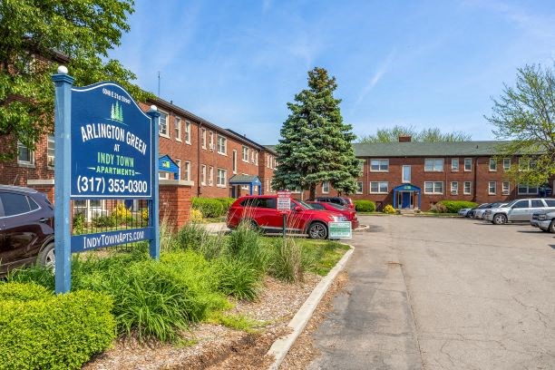 a red car parked in front of a building