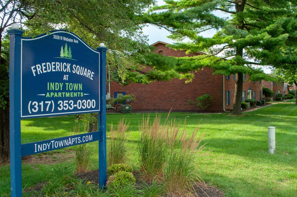 a blue sign in front of a brick building
