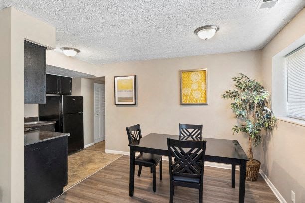 a dining room with a table and chairs and a kitchen