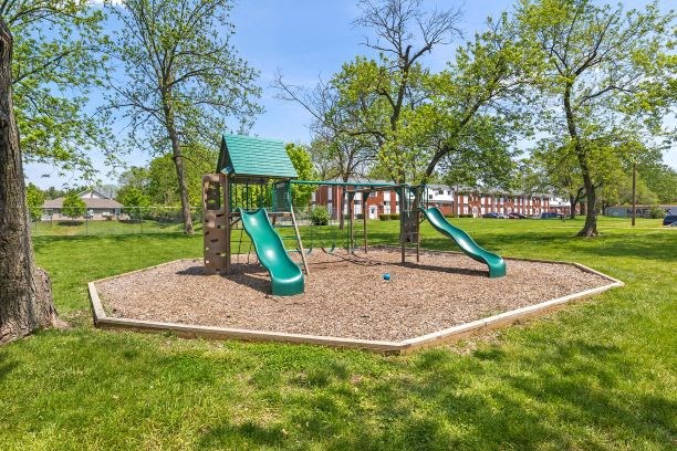 a playground with two slides in a park