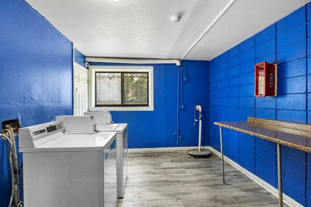 a blue bathroom with two sinks and a fire extinguisher