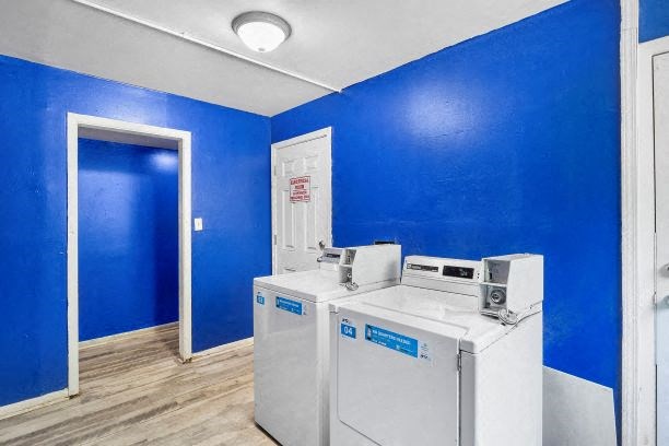 two washing machines in a room with blue walls