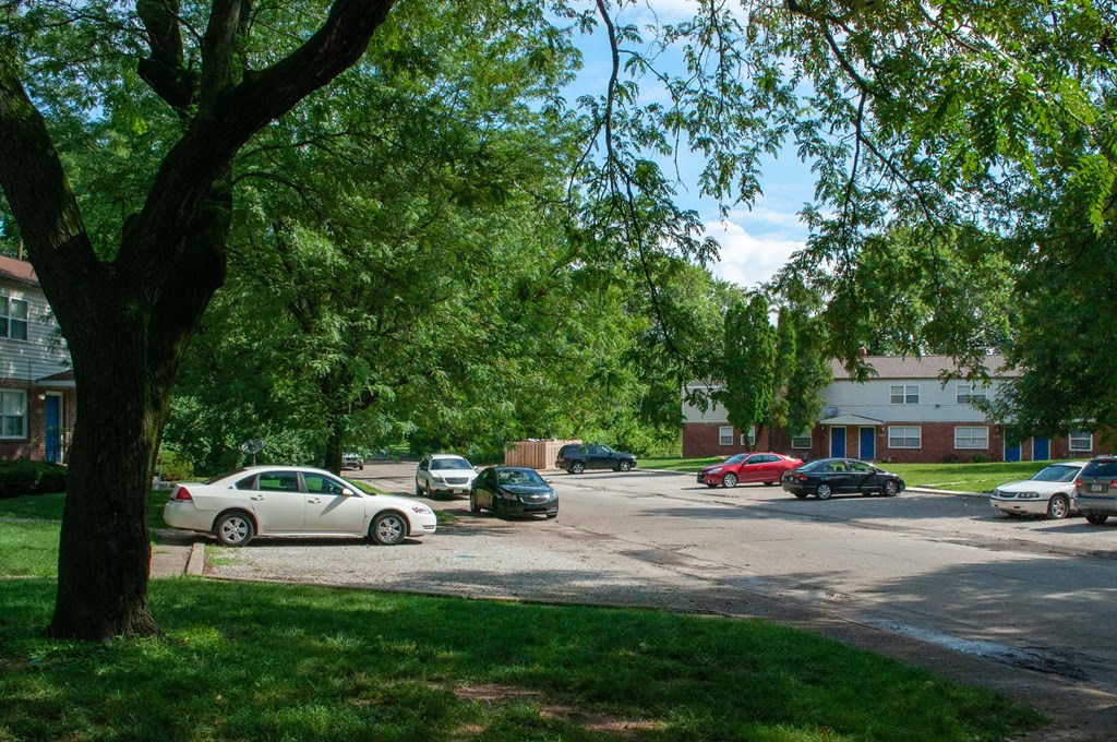 a parking lot with cars in front of a building