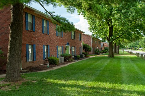 our apartments are located in a quiet neighborhood with green grass and trees