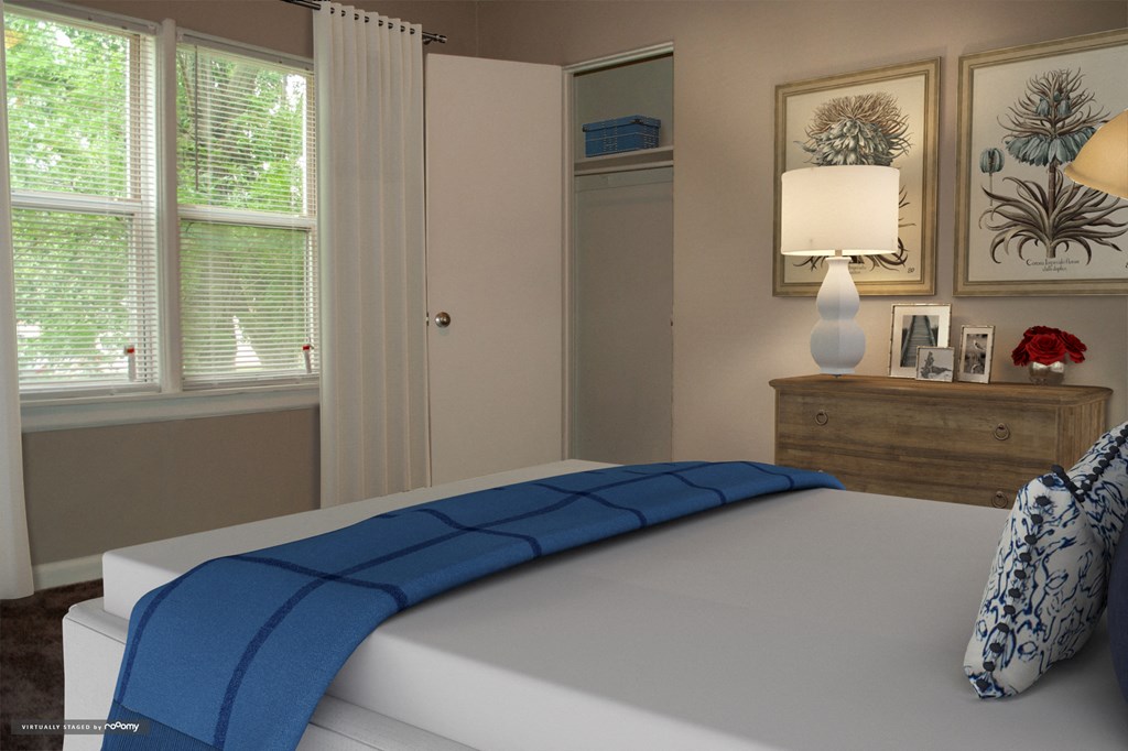 a bedroom with a white bed and a blue blanket on it