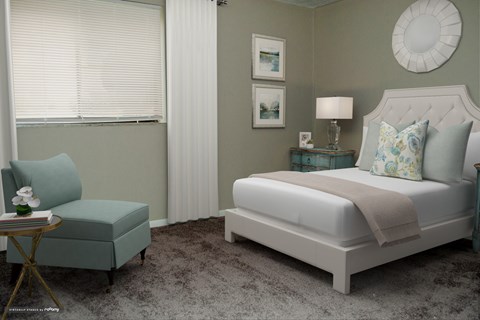 a bedroom with a bed and a chair and a window