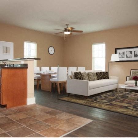 a living room with a white couch and a dining table