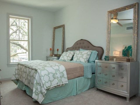 a bedroom with a bed and a dresser