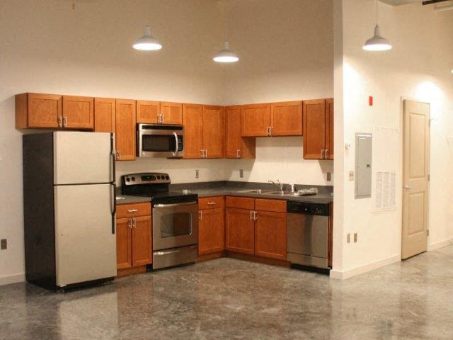 a kitchen with stainless steel appliances and wooden cabinets