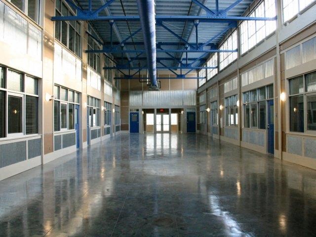 a large room with a shiny floor and windows