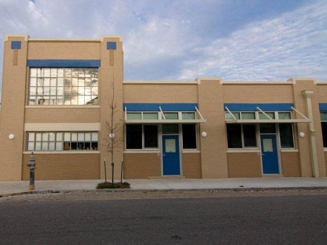 a building with blue doors and windows on a street