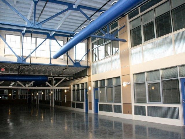the inside of a building with blue pipes