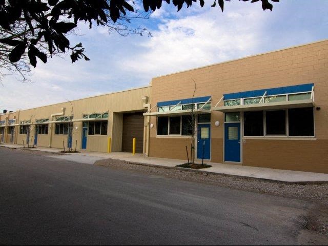 a building with a row of doors and a street