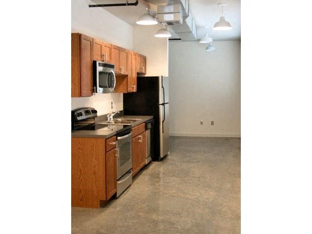 a kitchen with a stove and a refrigerator