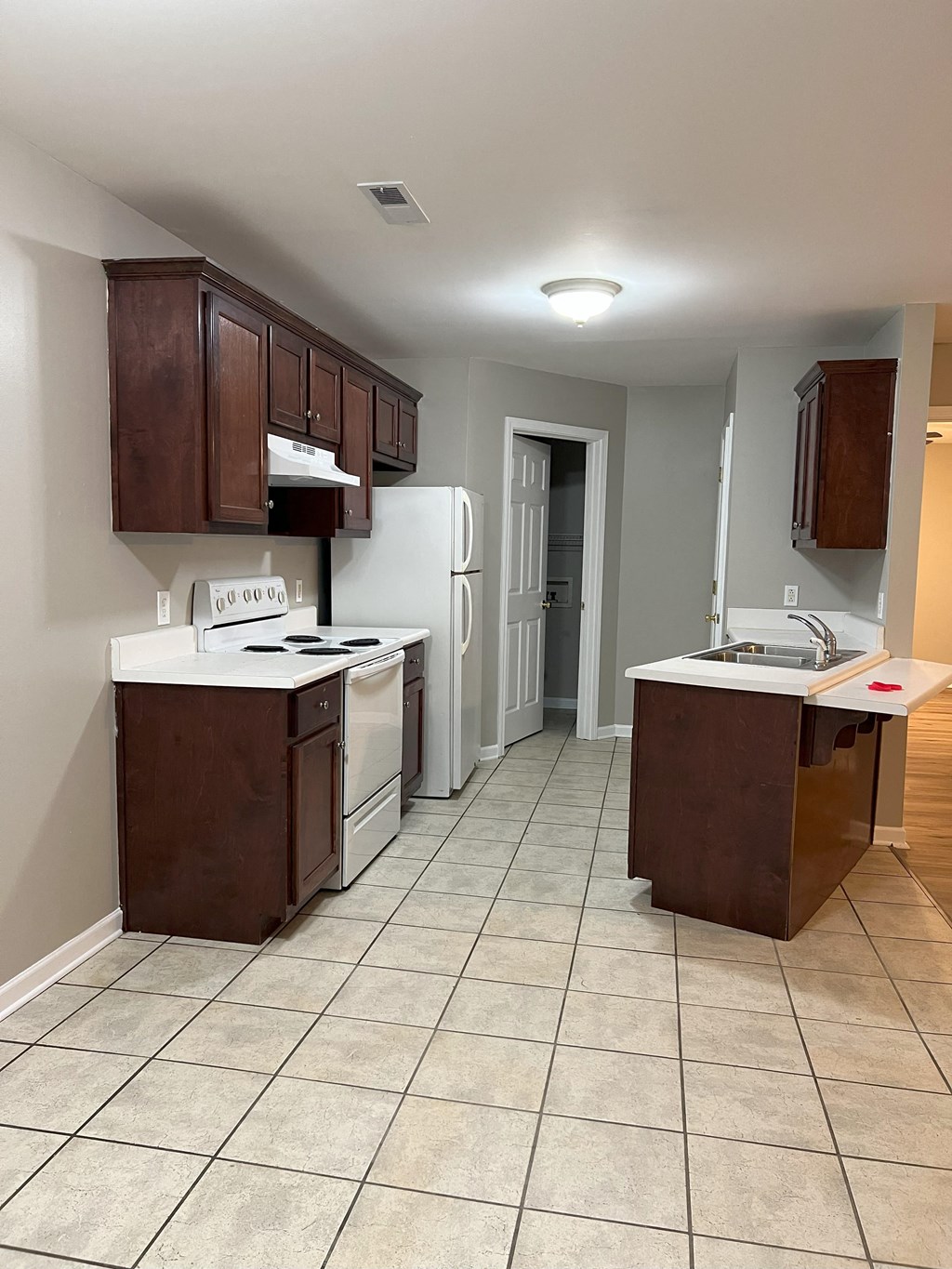 a kitchen with a stove refrigerator and a sink