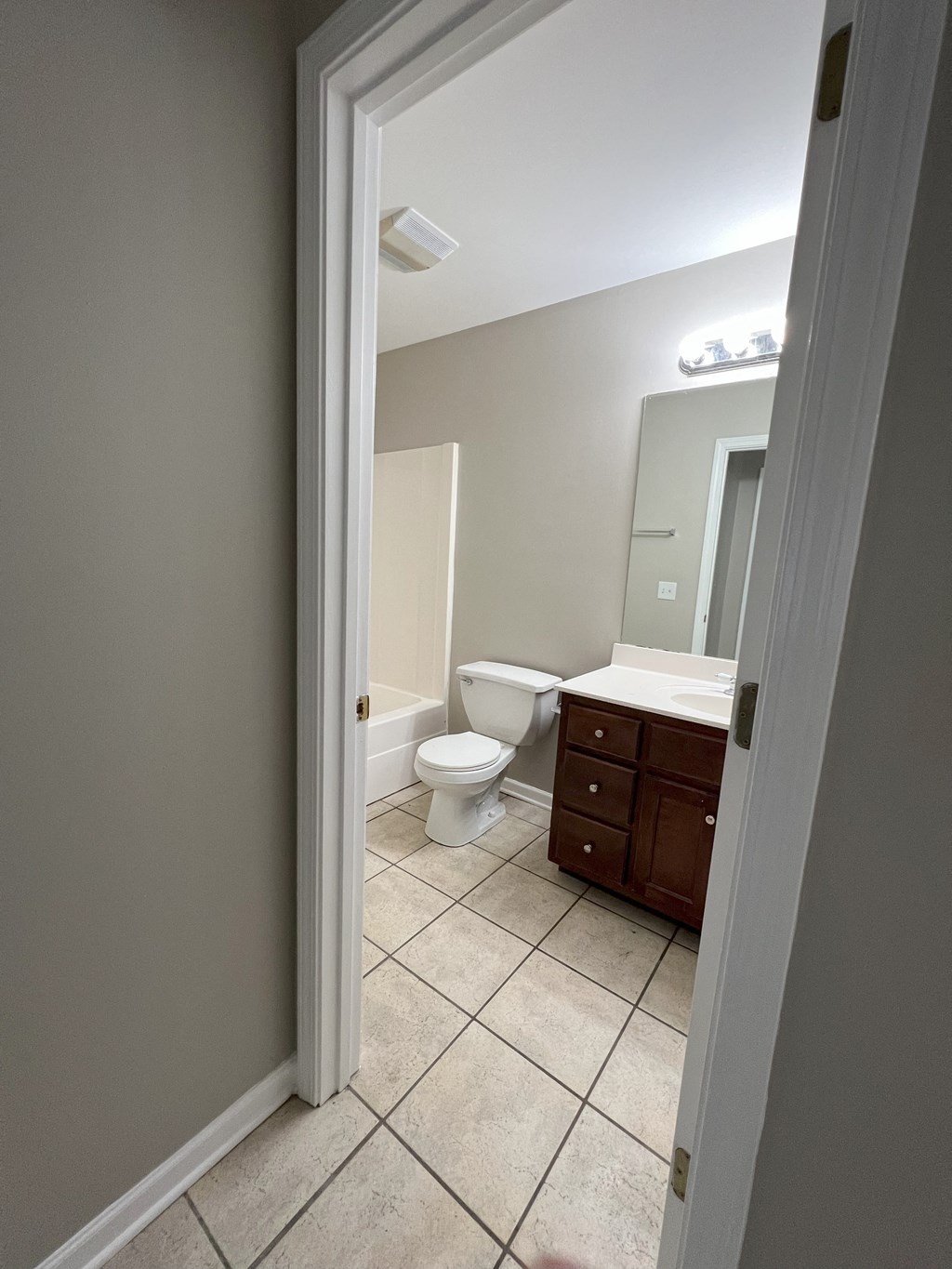 a bathroom with a toilet and a sink and a mirror