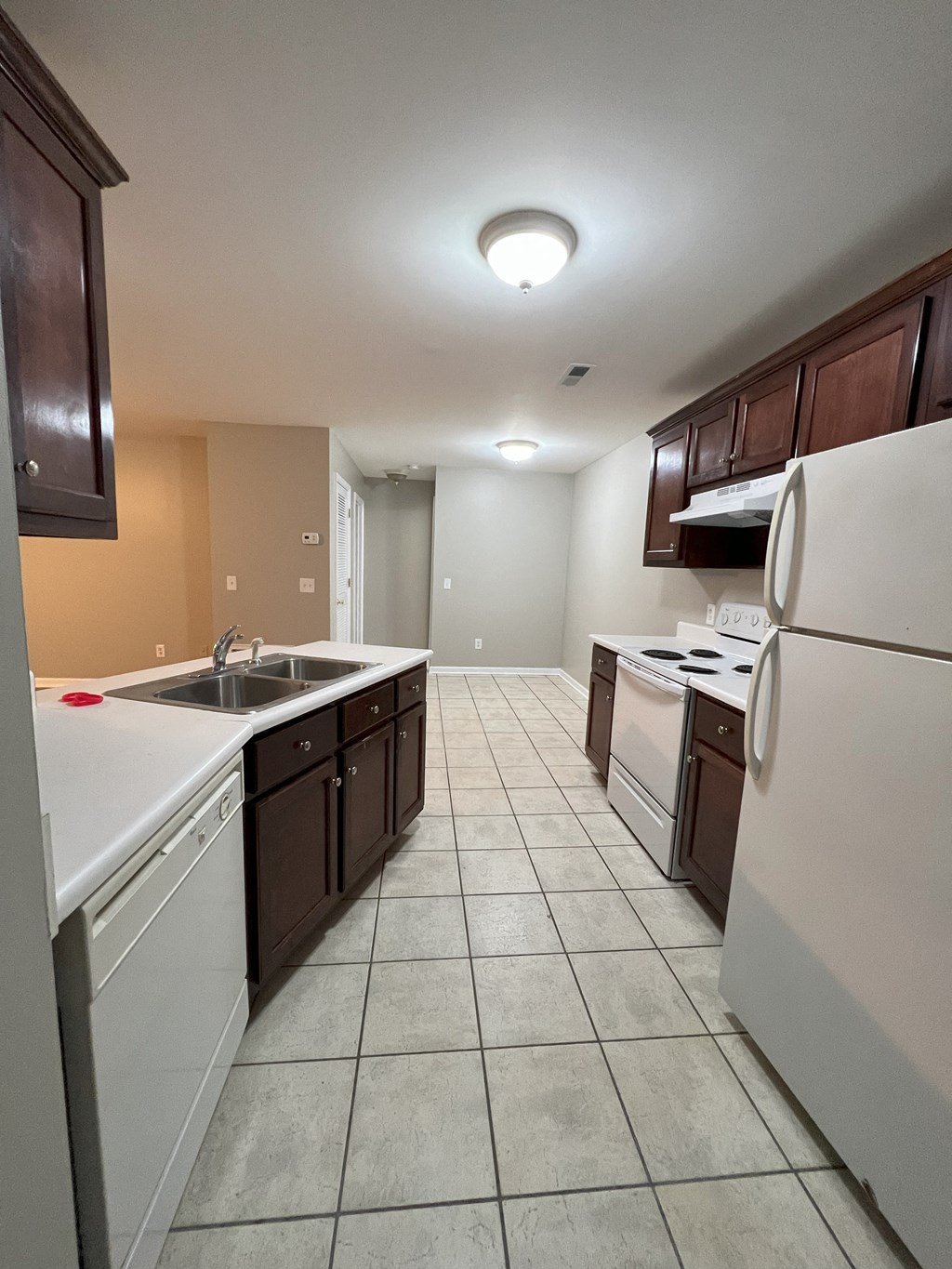 a kitchen with white appliances and brown cabinets