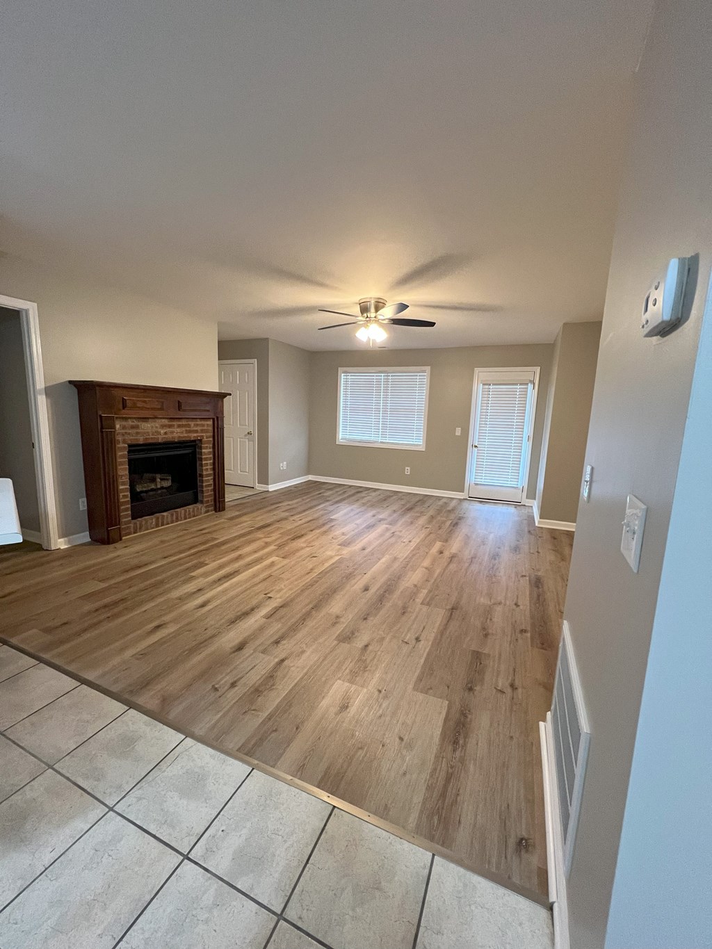 a living room with wooden floors and a fireplace