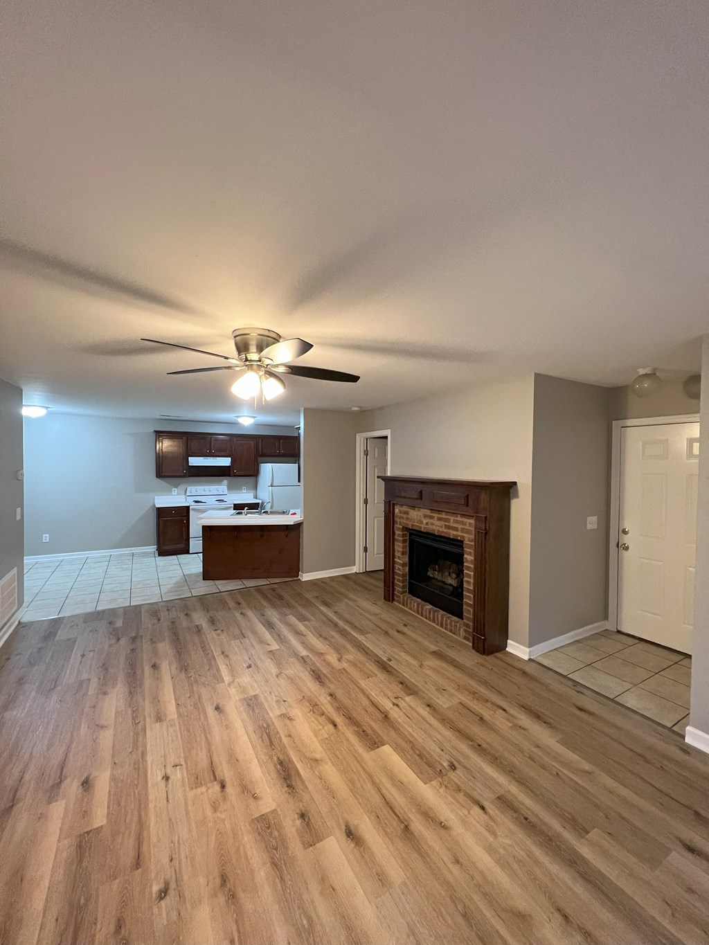 a living room with a fireplace and wooden floors