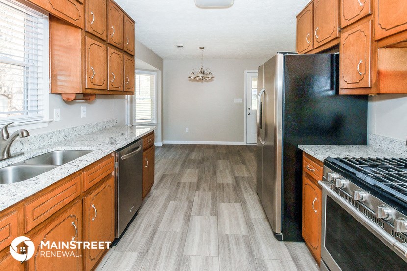 a kitchen with wooden cabinets and stainless steel appliances