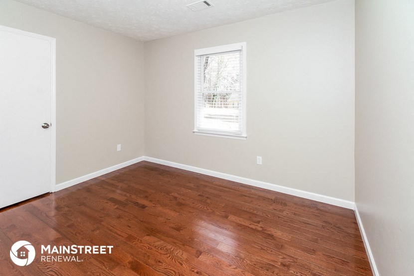 the interior of a room with wood floors and a window