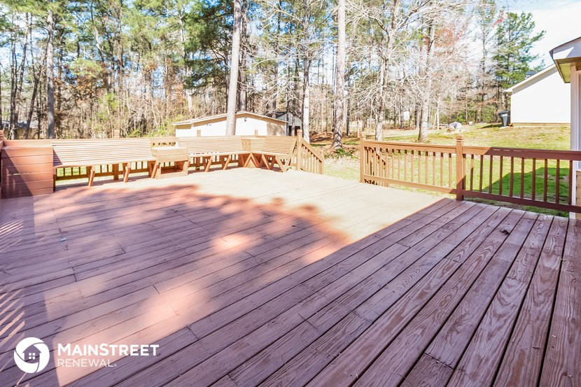 a large deck with a grill and a picnic table on it