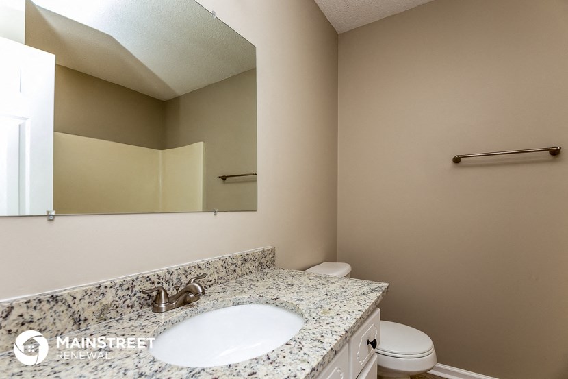 a bathroom with a sink and a toilet and a mirror