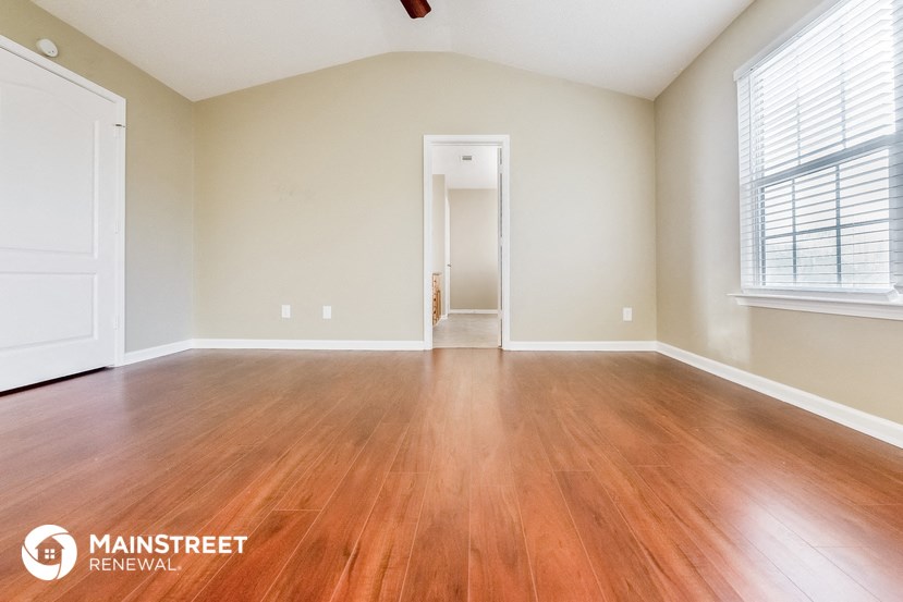 the living room of an empty house with wood floors