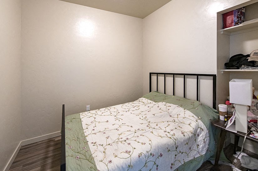 a small bedroom with a bed and a closet