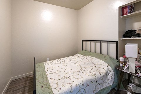 a small bedroom with a bed and a closet