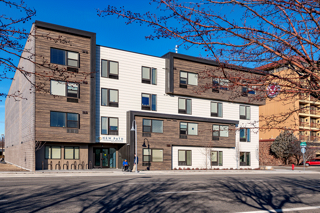 a large apartment building on the corner of a street