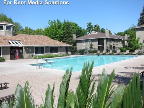 Pool with lounge chairs l The Marina Apartments in Modesto CA 