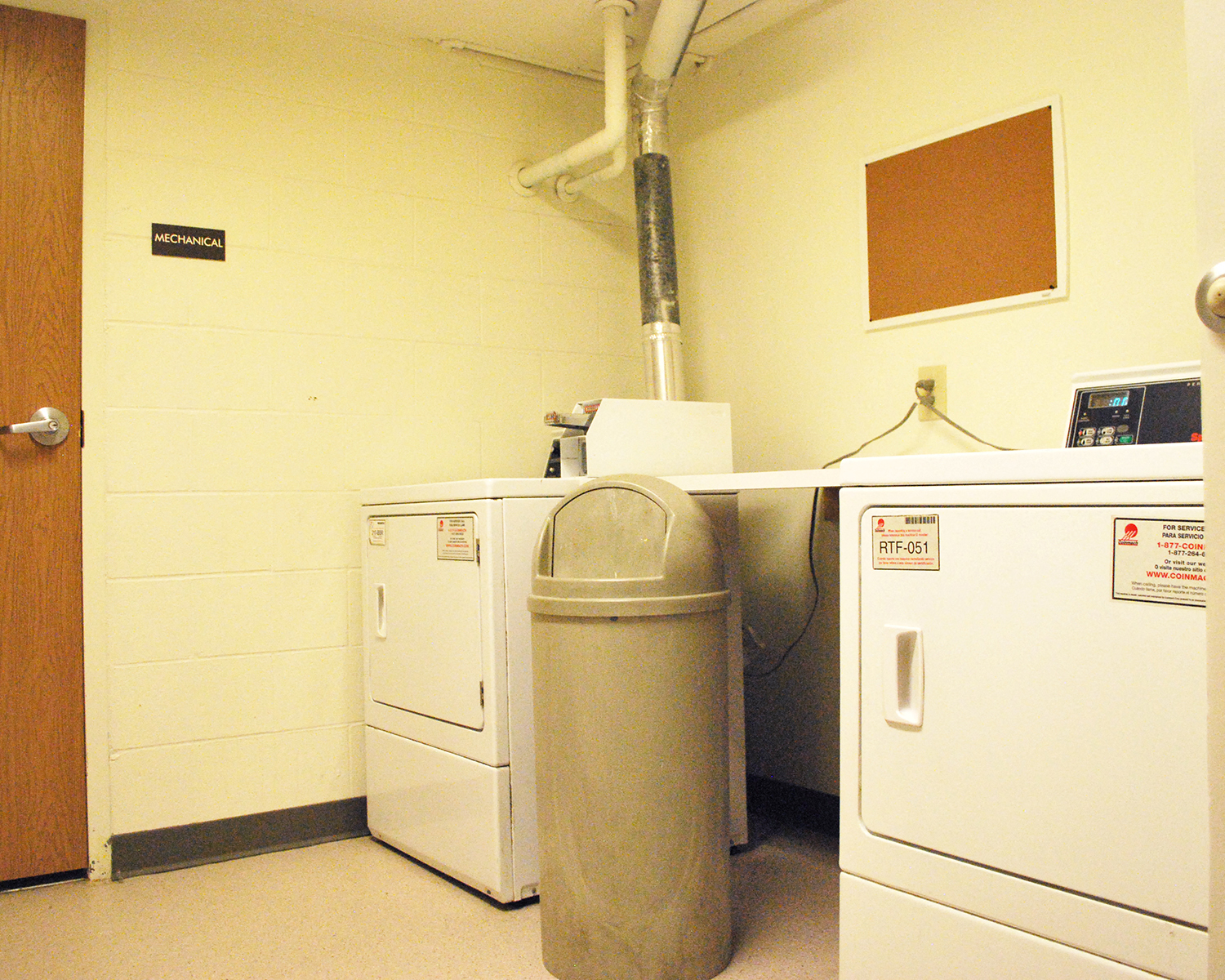 a laundry room with two washers and two washing machines