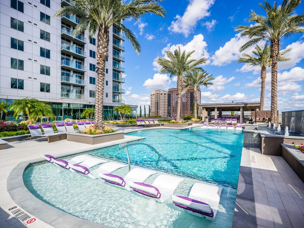 a swimming pool at a hotel with palm trees