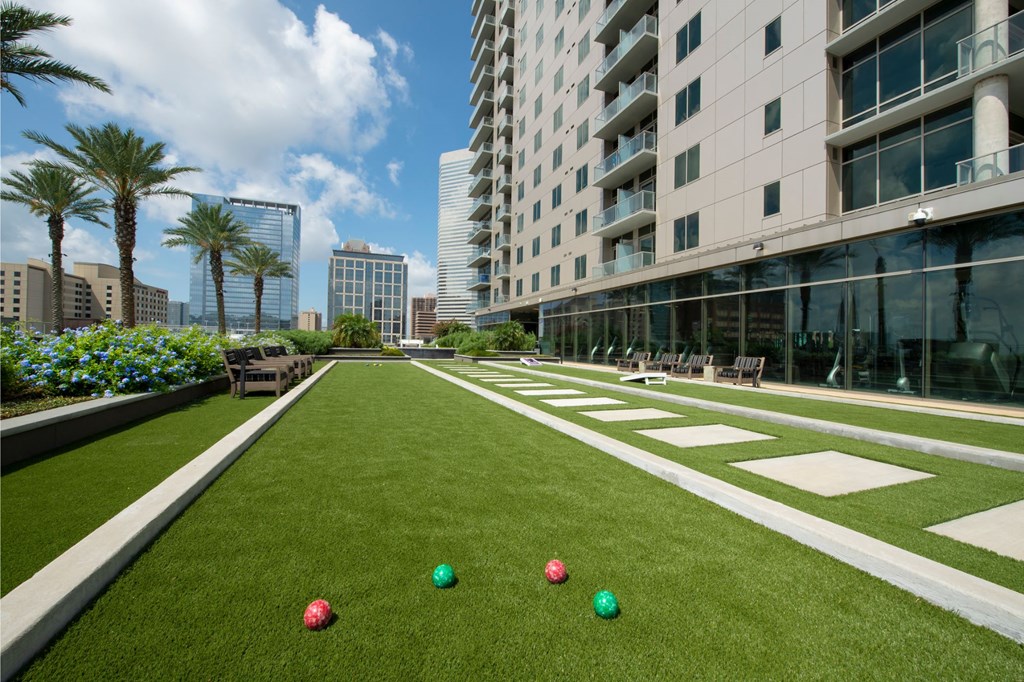 a lawn with balls on it in front of a tall building