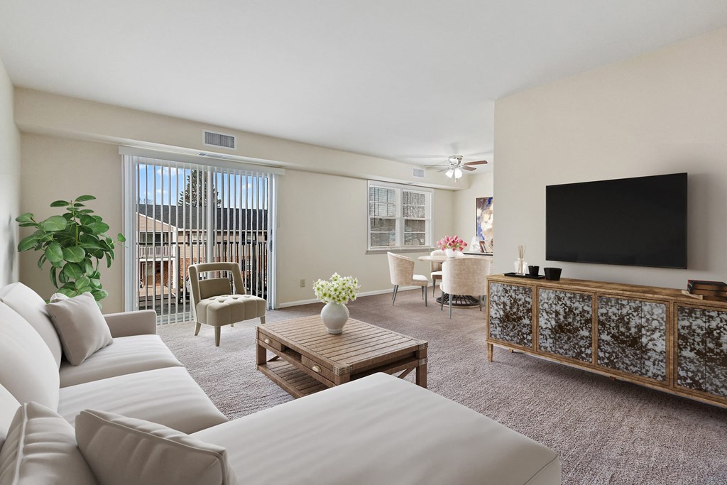 a living room with a white couch and a television