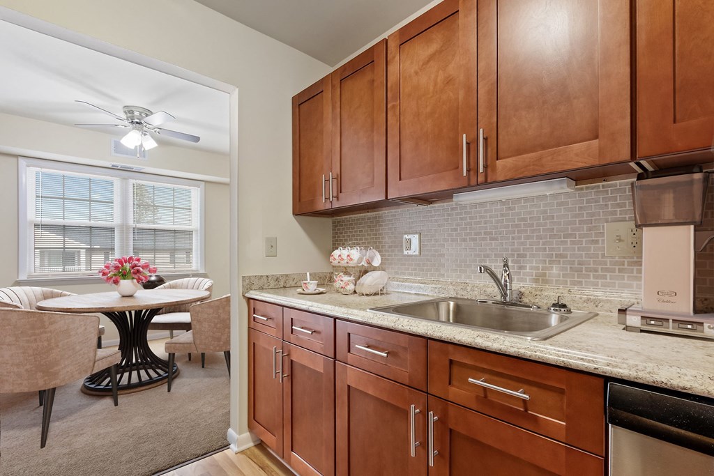 a kitchen with wooden cabinets and a sink and a table