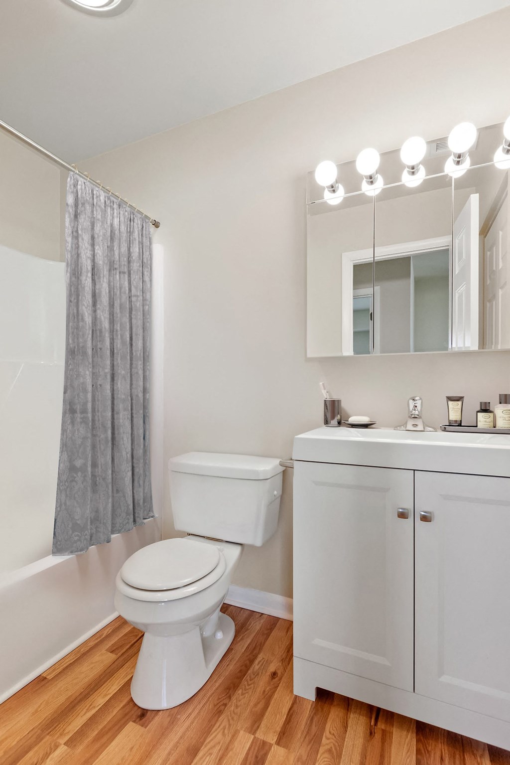 a bathroom with a toilet and a sink and a mirror