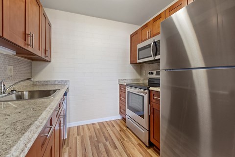 a kitchen with stainless steel appliances and wooden cabinets