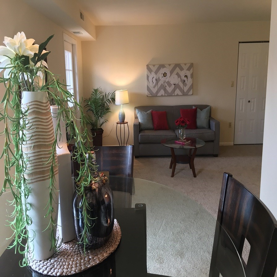 a living room with a table and a couch in it