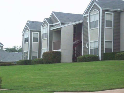 a building with a green lawn in front of it