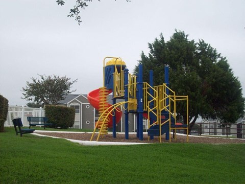 a playground with a large playset in a park