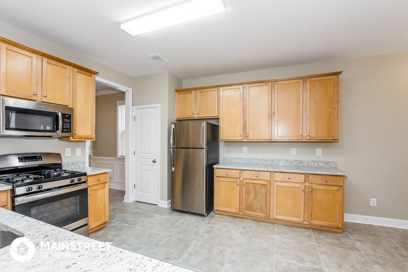 a kitchen with wooden cabinets and stainless steel appliances