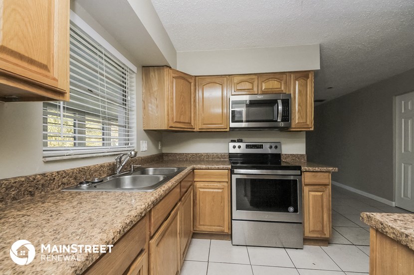 a kitchen with wooden cabinets and granite counter tops
