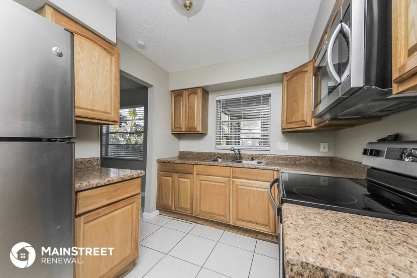 a kitchen with wooden cabinets and granite counter tops