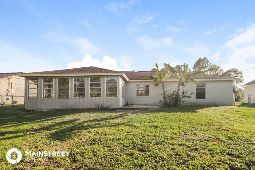front view of a white house with a yard and grass