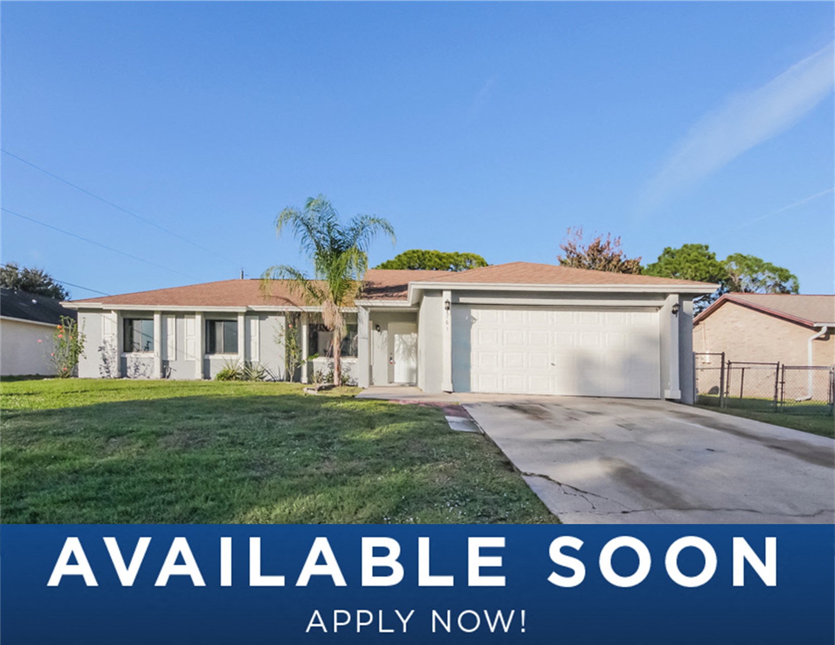 a house with a lawn and a garage door