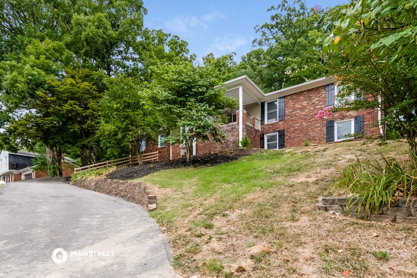 a house on a hill with a road in front of it